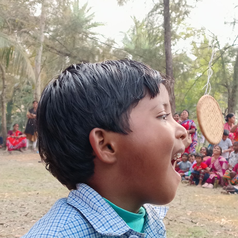 A boy laughing during a festival game at one of our centres