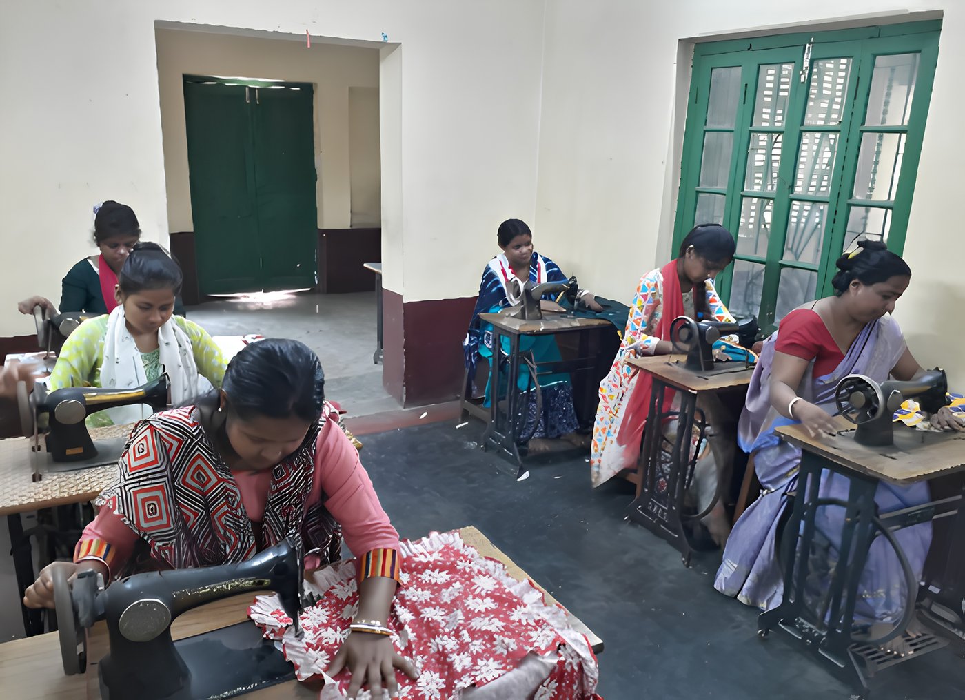 Women sewing at machines during the Baniniketan tailoring programme
